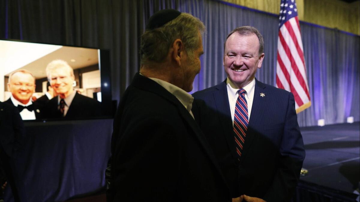 Sheriff Jim McDonnell, right, with Andrew Friedman of Los Angeles on election night at the JW Marriott Los Angeles L.A. LIVE in November 2018.