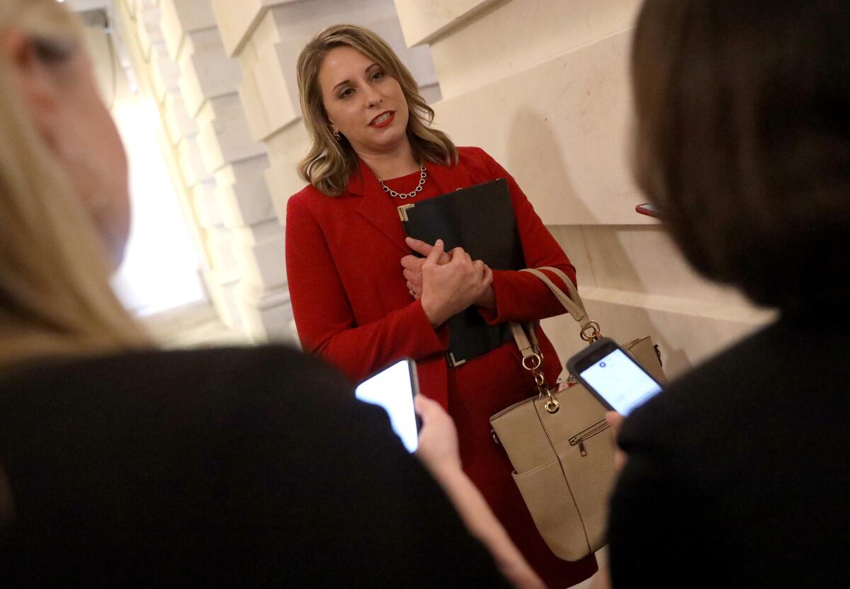 Katie Hill answers questions from reporters after her final speech in the House of Representatives on Oct. 31. Hill announced she was resigning from Congress.