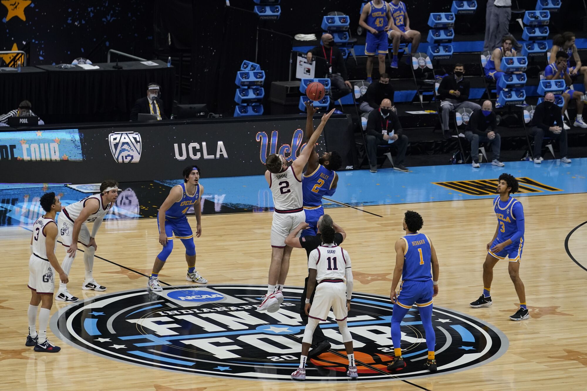 Gonzaga forward Drew Timme, left, and UCLA forward Cody Riley fight for the opening tipoff 