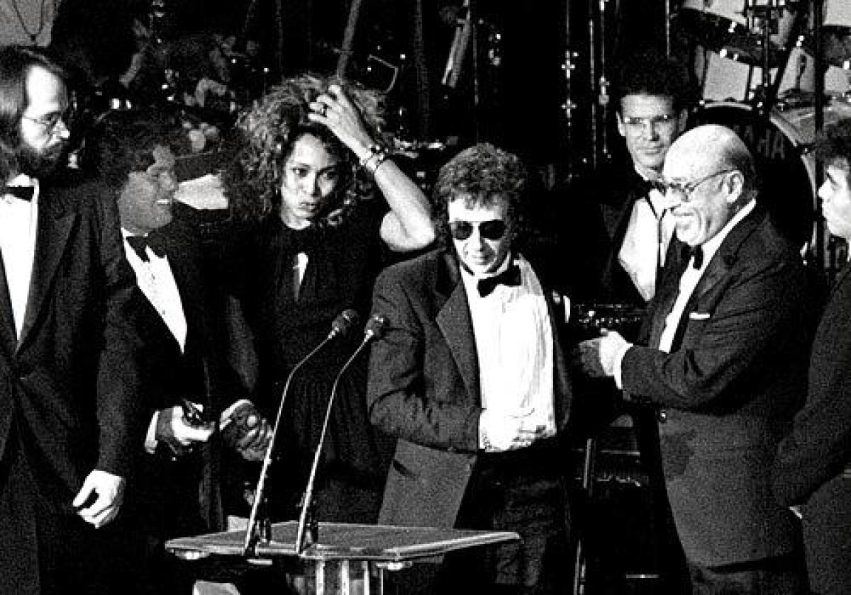 Phil Spector flanked by Tina Turner and Ahmet Ertegun at the Rock and Roll Hall of Fame Awards in NYC, January 1989.