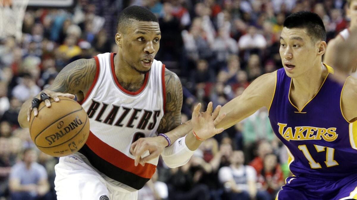 Portland Trail Blazers guard Damian Lillard, left, drives on Lakers guard Jeremy Lin during the Lakers' 98-94 loss on Jan. 5.