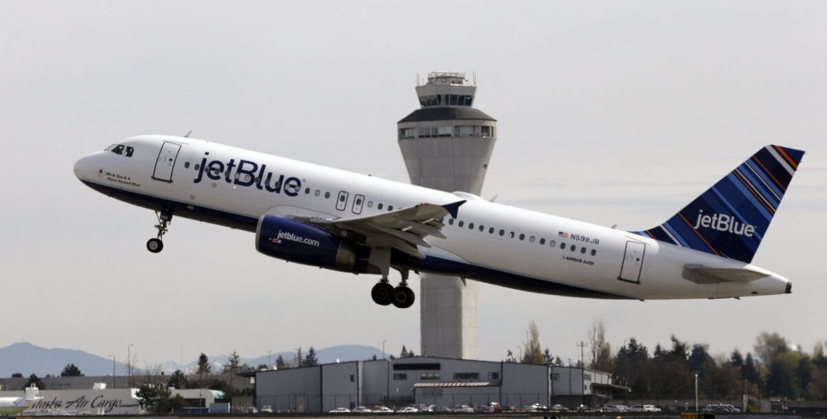 A JetBlue plane departs from Seattle-Tacoma International Airport in 2013. The carrier announced that it will begin non-stop service between Cuba and New York's John F. Kennedy International Airport.