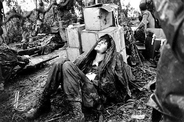 This photo by Van Es shows a wounded U.S. paratrooper grimacing in pain while waiting for medical evacuation in the A Shau Valley near the South Vietnamese-Laotian border.