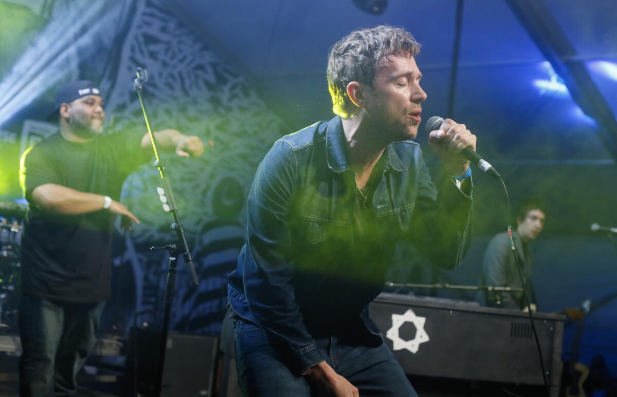 Damon Albarn, right, joined by De La Soul's Vincent Mason performs during the SXSW Music Festival on March 14, 2014, in Austin, Texas.