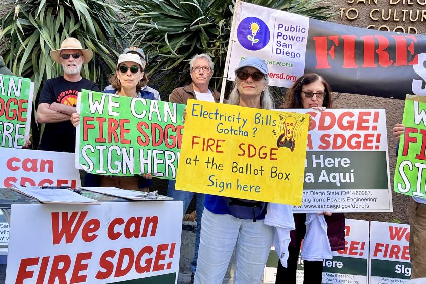 About 35 supporters of the Power San Diego Campaign gather Tuesday at Civic Center Plaza in support of a proposal on the November ballot that would ask voters to replace San Diego Gas & Electric with a municipal utility.