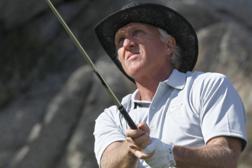 Greg Norman watches his tee shot on the 17th hole during a practice round on the Arnold Palmer Private course at PGA West for the 2012 Humana Challenge golf tournament in La Quinta.