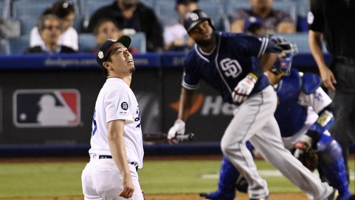 Dodgers pitcher Kenta Maeda watches a two-run home run by San Diego Padres center fielder Manuel Margot during the eighth inning of the Dodgers' 3-1 loss Saturday.