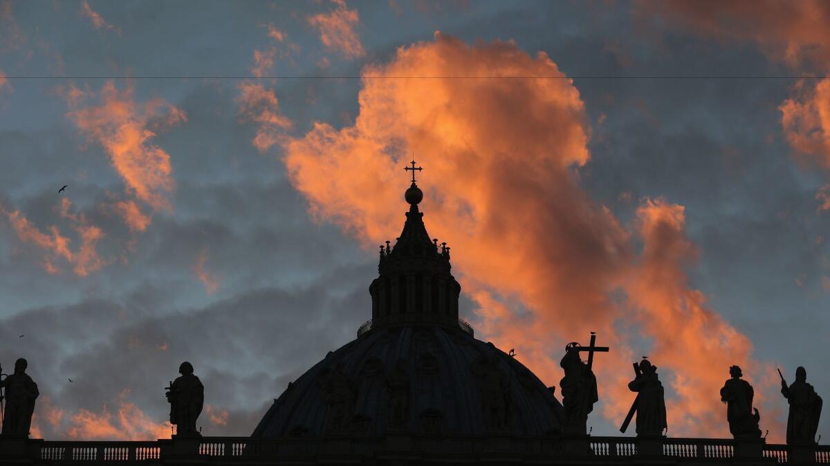 The sun sets over St Peter's Basilica at the Vatican on March 9, 2013.