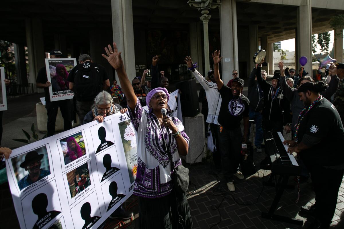 Lorraine Morland speaks and sings to a crowd of supporters gathered outside City Hall to pay tribute to homeless people who have died this year in Los Angeles.