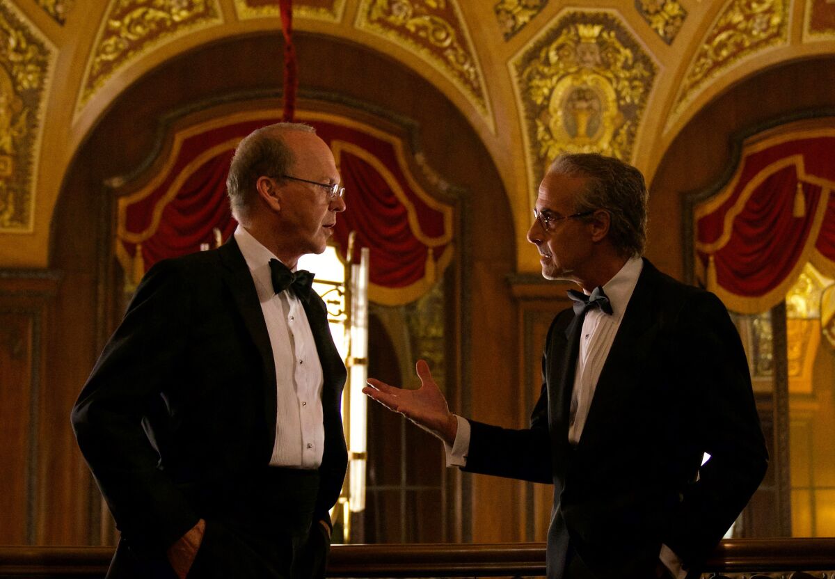 This image released by Netflix shows Michael Keaton, left, and Stanley Tucci in a scene from "Worth." (Netflix via AP)