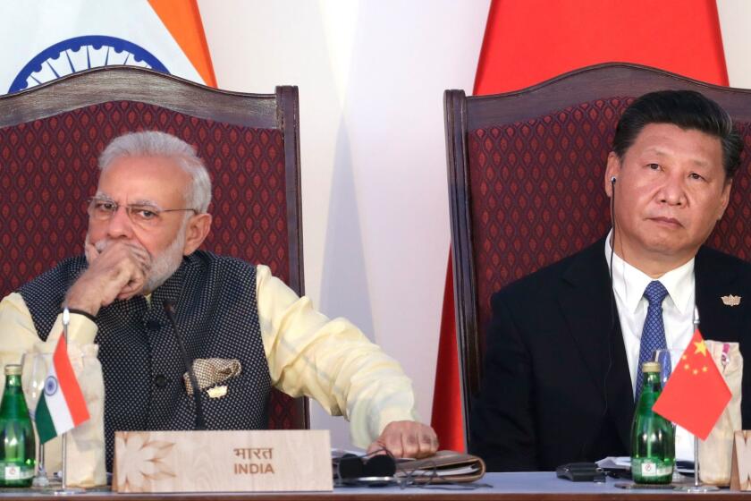 FILE - In this Oct. 16, 2016, file photo, Indian Prime Minister Narendra Modi, left, and Chinese President Xi Jinping listen to a speech during the BRICS Leaders Meeting with the BRICS Business Council in Goa, India. India and China have faced off frequently since fighting a bloody 1962 war that ended with China seizing control of some territory. Indiaâs army chief warned in July 2017 that Indiaâs army was capable of fighting â2 1/2 warsâ if needed to secure its borders. The dispute was discussed briefly without resolution by Xi and Modi on the sidelines of the G-20 summit in Hamburg, Germany. (AP Photo/Manish Swarup, File)
