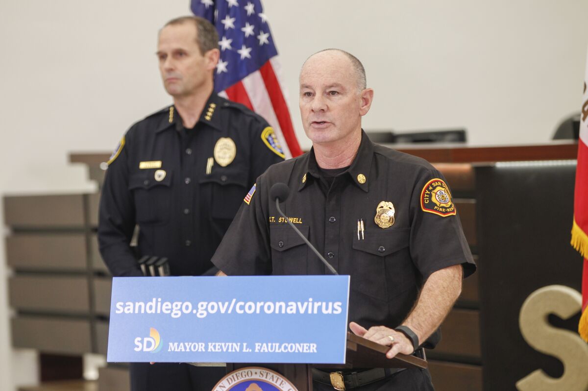 San Diego Fire Chief Colin Stowell (right) speaks at a City Hall in March 2020.