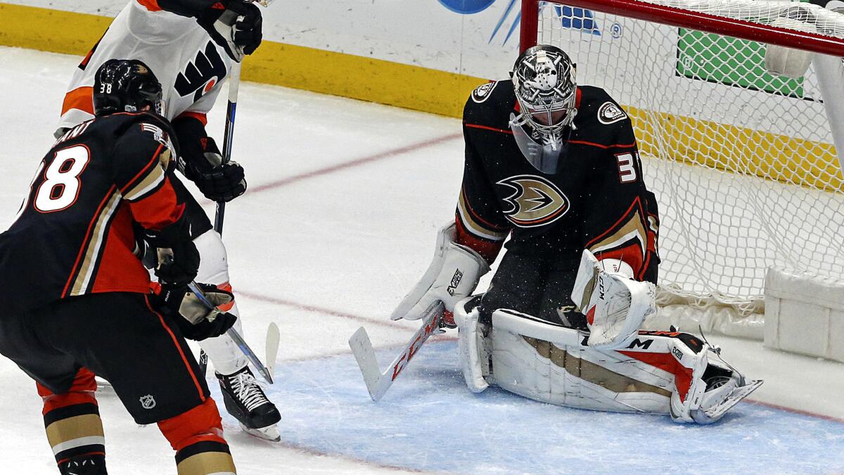 Anaheim Ducks goalie John Gibson, right, misses getting his glove on a goal during the second period of Saturday's game against the Philadelphia Flyers.
