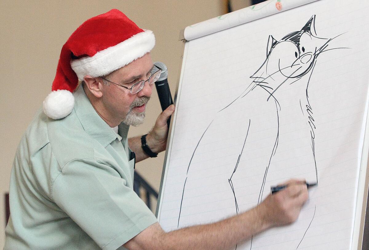 Artist Frans Vischer draws Fuddles the cat from his children's book for students at R.D. White Elementary on Tuesday, December 17, 2013.