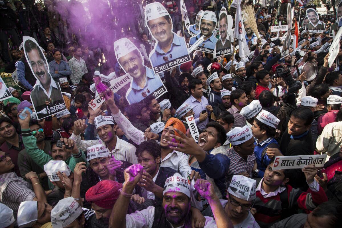 Supporters of the Aam Aadmi Party celebrate their election victory in New Delhi on Feb. 10.