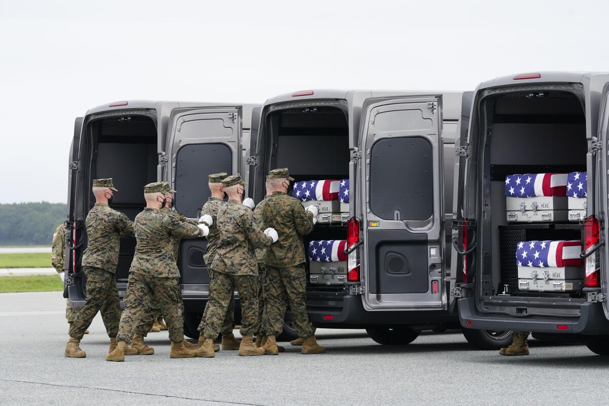 A Marine Corps carry team loads a transfer case containing the remains of Marine Corps Lance Cpl. Jared Schmitz, 20.