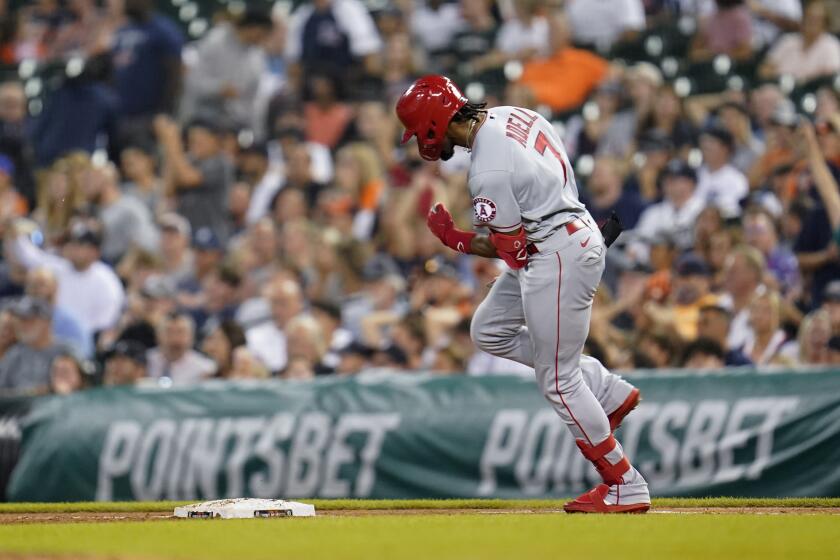 Los Angeles Angels' Jo Adell (7) reacts to hitting a grand slam in the ninth inning of a baseball game against the Detroit Tigers in Detroit, Tuesday, Aug. 17, 2021. (AP Photo/Paul Sancya)