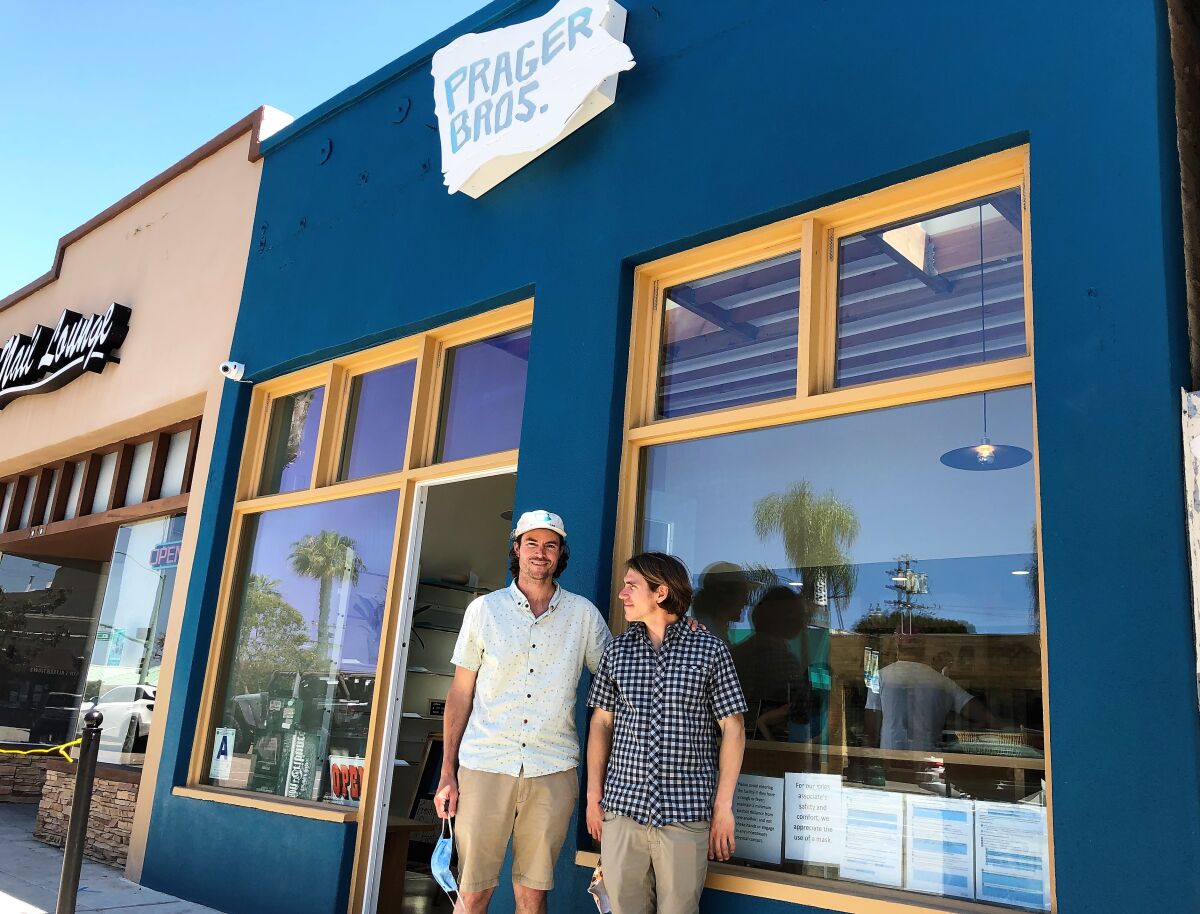 Siblings Louie Prager, left, and Clinton Prager wait outside their newly opened Prager Bros. Artisan Breads store in downtown Encinitas on April 25. Despite opening the shop during the pandemic on April 17, the brothers say the shop has been surprisingly busy.