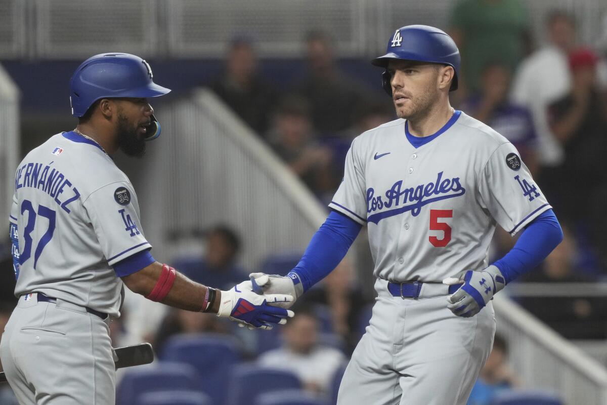 Los Angeles Dodgers' Freddie Freeman (5) celebrates a two-run home run with Teoscar Hernández.