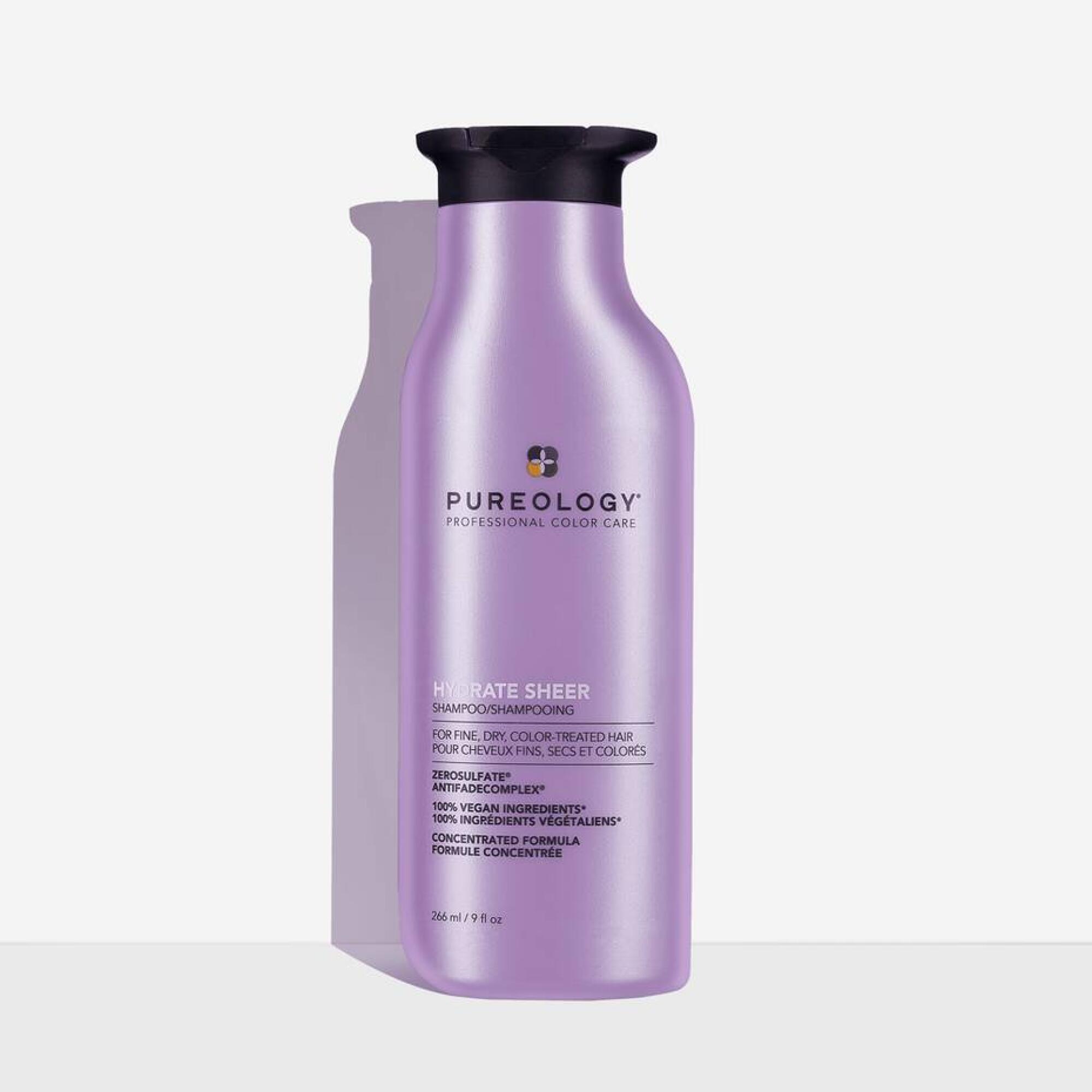 A purple Pureology Hydrate Sheer shampoo bottle on a white background