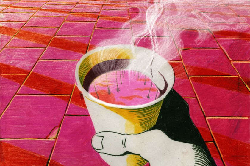 A hand holding a steaming cup of coffee