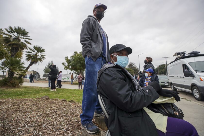 Los Angeles, CA - February 09: George Darby, 77, left, and his wife Althea Darby, 69, wait for their turn to get COVID-19 vaccine at a mobile vaccination site launched by Los Angeles Councilman Curren Price Jr. at South Park Recreation Center on Tuesday, Feb. 9, 2021 in Los Angeles, CA.(Irfan Khan / Los Angeles Times)
