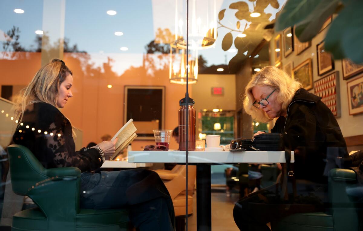 Enthusiasts read during a Silver Lake Reading Club meeting at the LAMILL coffee house.
