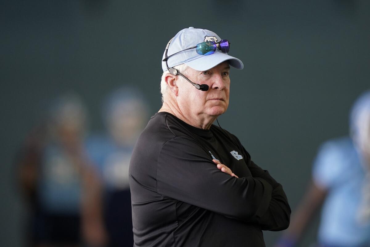 FILE - North Carolina coach Mack Brown watches during an NCAA college football practice in Chapel Hill, N.C., in this Thursday, Aug. 5, 2021, file photo. The Tar Heels return 18 starters from an eight-win team and are picked to win the ACC's Coastal Division. (AP Photo/Gerry Broome, File)