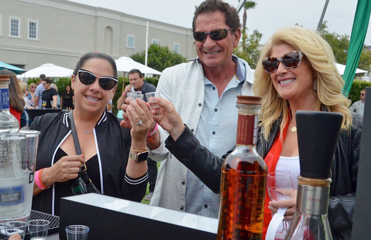 From left, Krissey Nardecchia, Bryan Zatica and Lisa VanCourt toasted Maestro Dobel tequila.