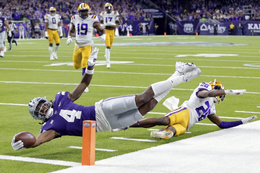 Kansas State wide receiver Malik Knowles (4) gets the ball into the end zone to score past LSU defensive back Damarius McGhee (26) during the first half of the Texas Bowl NCAA college football game Tuesday, Jan. 4, 2022, in Houston. (AP Photo/Michael Wyke)