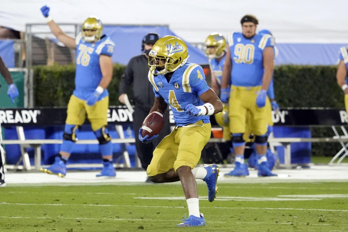 UCLA defensive back Stephan Blaylock runs with the ball after intercepting a pass against Arizona.