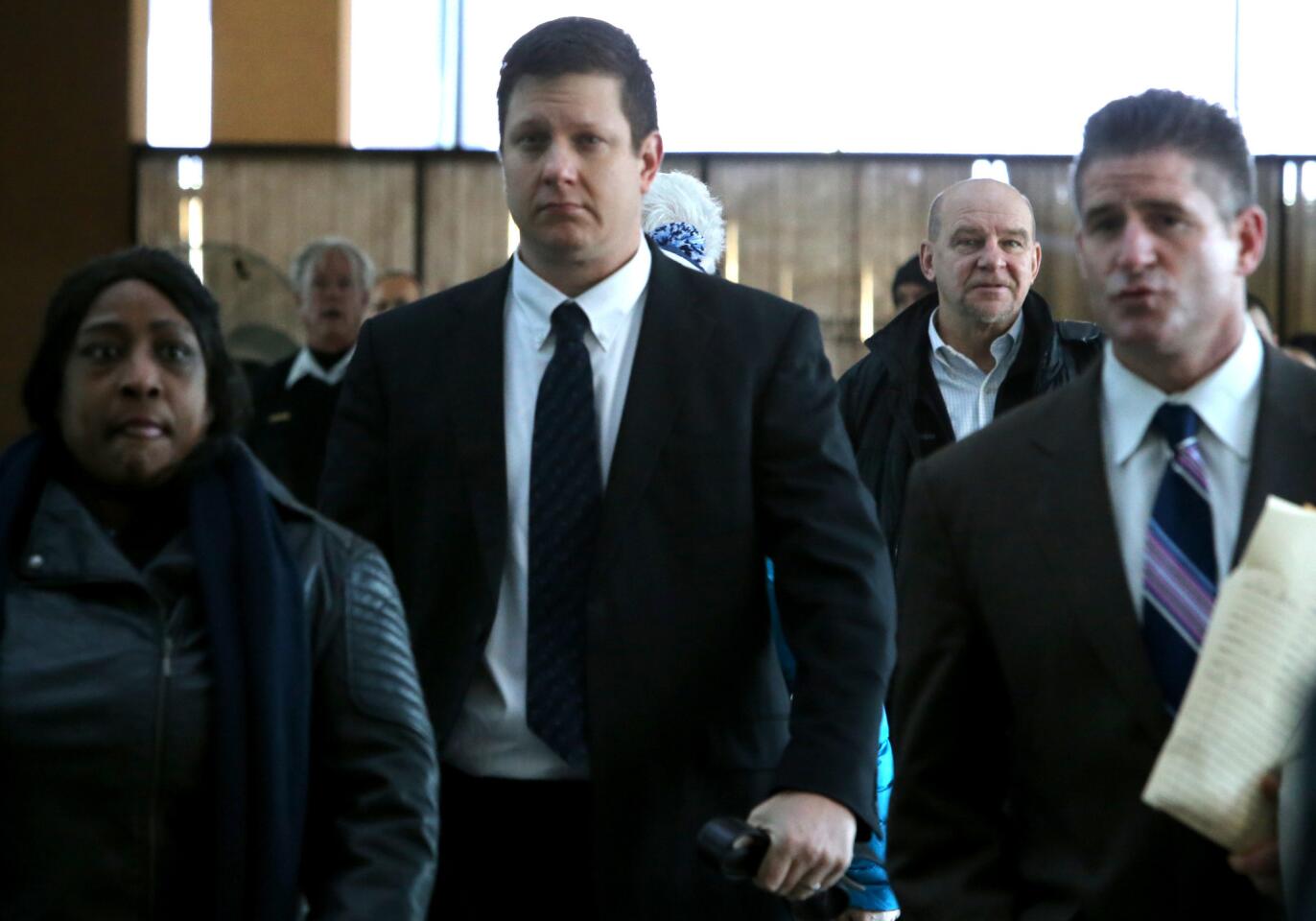 Chicago police Officer Jason Van Dyke, center, arrives at the Leighton Criminal Court Building on Dec. 18, 2015, for a hearing announcing his indictment on six counts of first-degree murder and one count of official misconduct for fatally shooting 17-year-old Laquan McDonald.