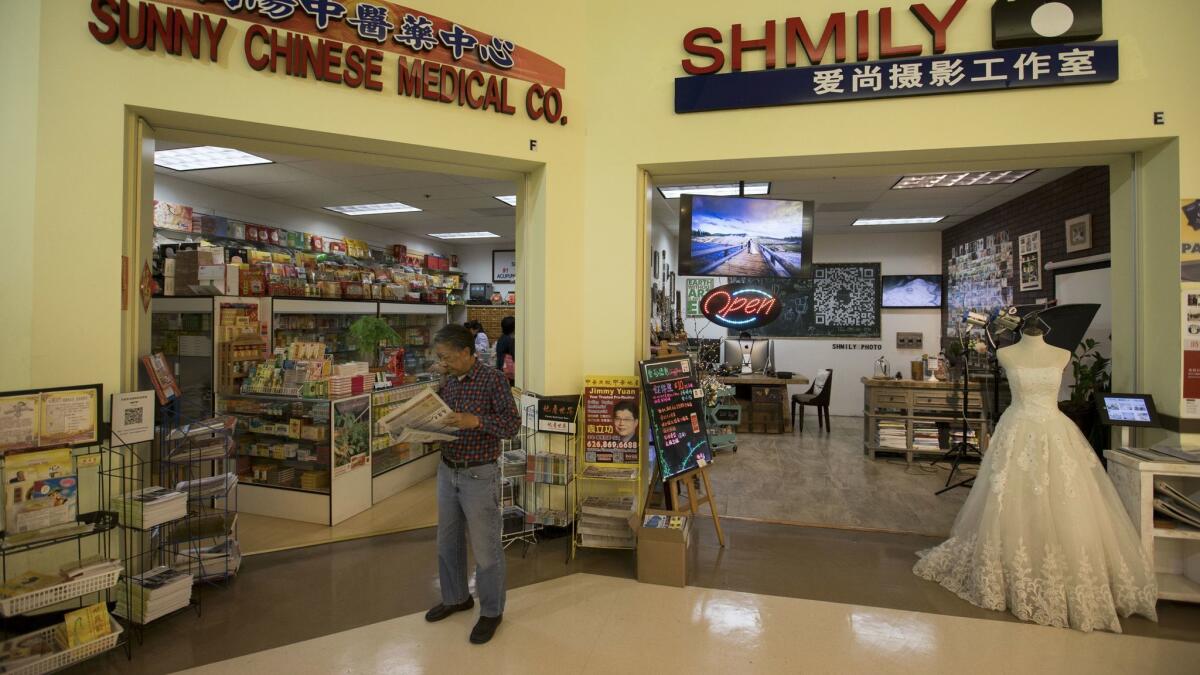 While shopping at 99 Ranch Market, customers can tap other vendors or services to stock up on herbal medicine or book wedding portraits. (Allen J. Schaben / Los Angeles Times)