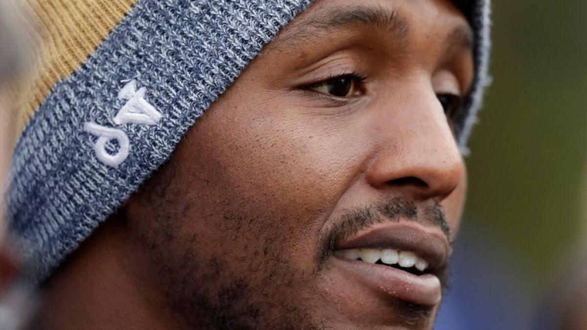 Rams defensive end Robert Quinn speaks to the media after a practice session at Pennyhill Park Hotel in Bagshot, England on Oct. 20.