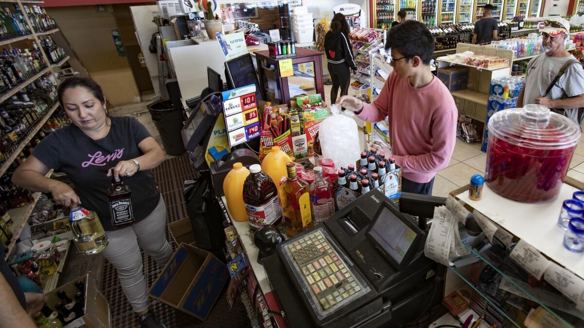Coachella-goer Adnan Aga, 23, of Pittsburgh, stocks up on liquor and other supplies at Sherman Liquor before attending the music festival.