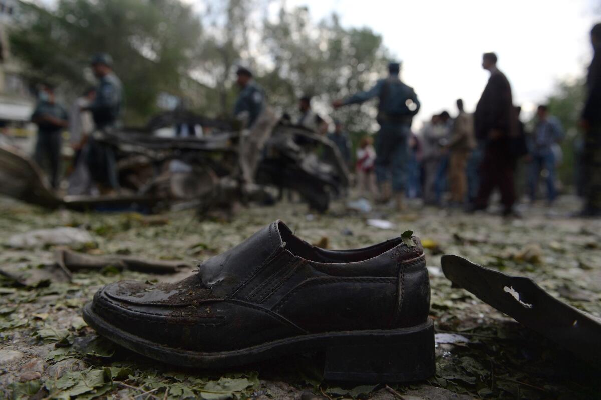 A victim's shoe lies on the ground as Afghan police secure the site of a suicide attack in Kabul on Tuesday.