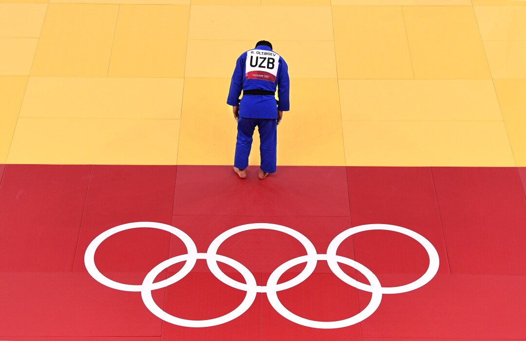 Uzbekistan's Bekmurod Oltiboev bows after losing a men's 100-kilo judo match.