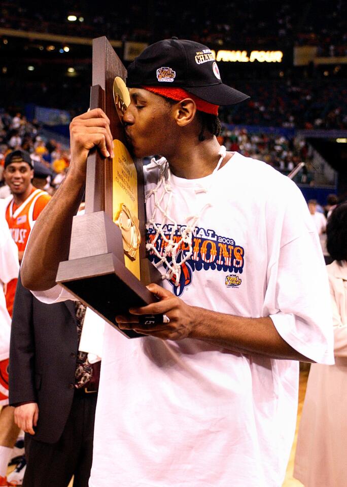 Syracuse's Carmelo Anthony kisses the NCAA Championship trophy after Syracuse beat Kansas in New Orleans.