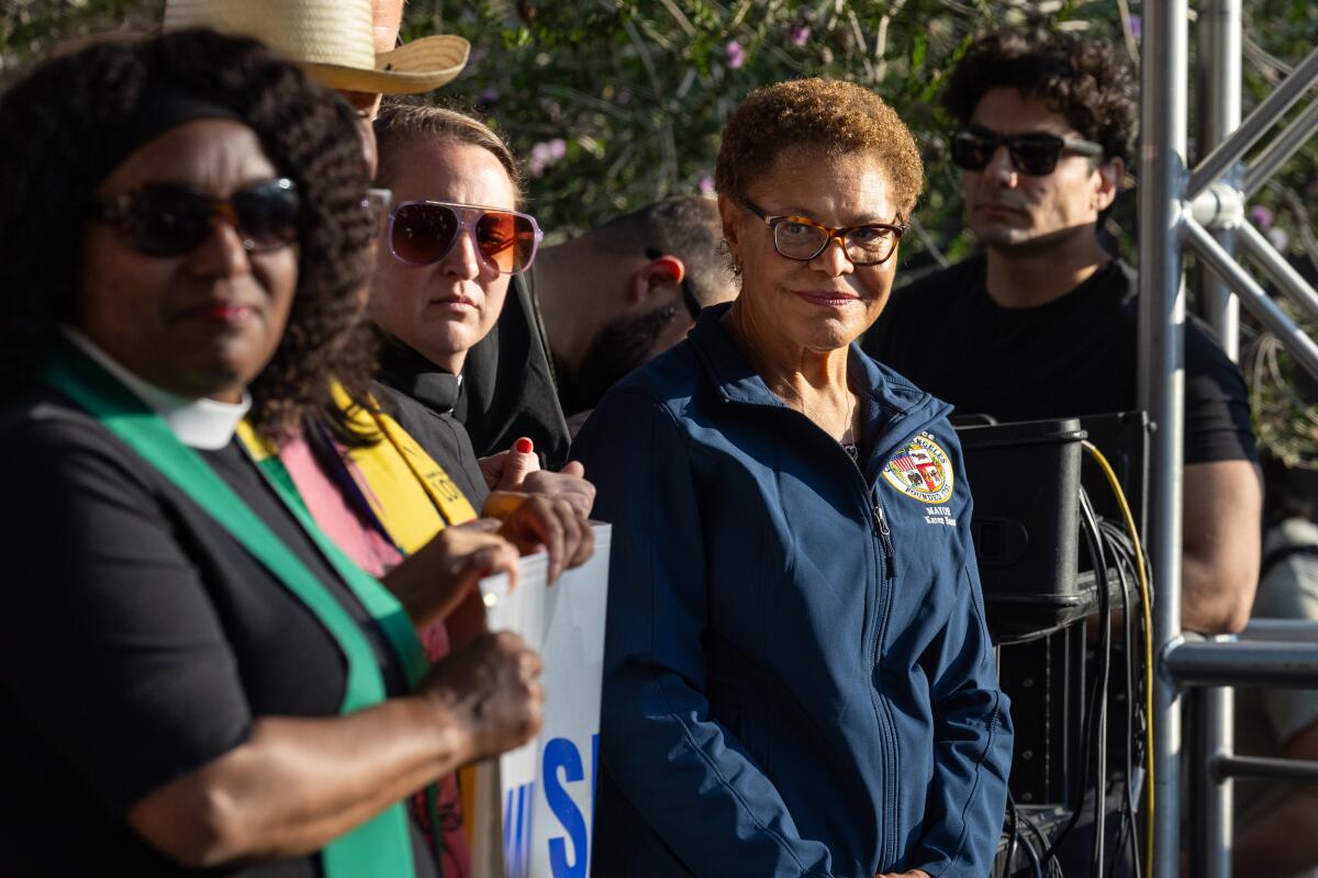 Mayor Karen Bass gathers with others during a public appearance