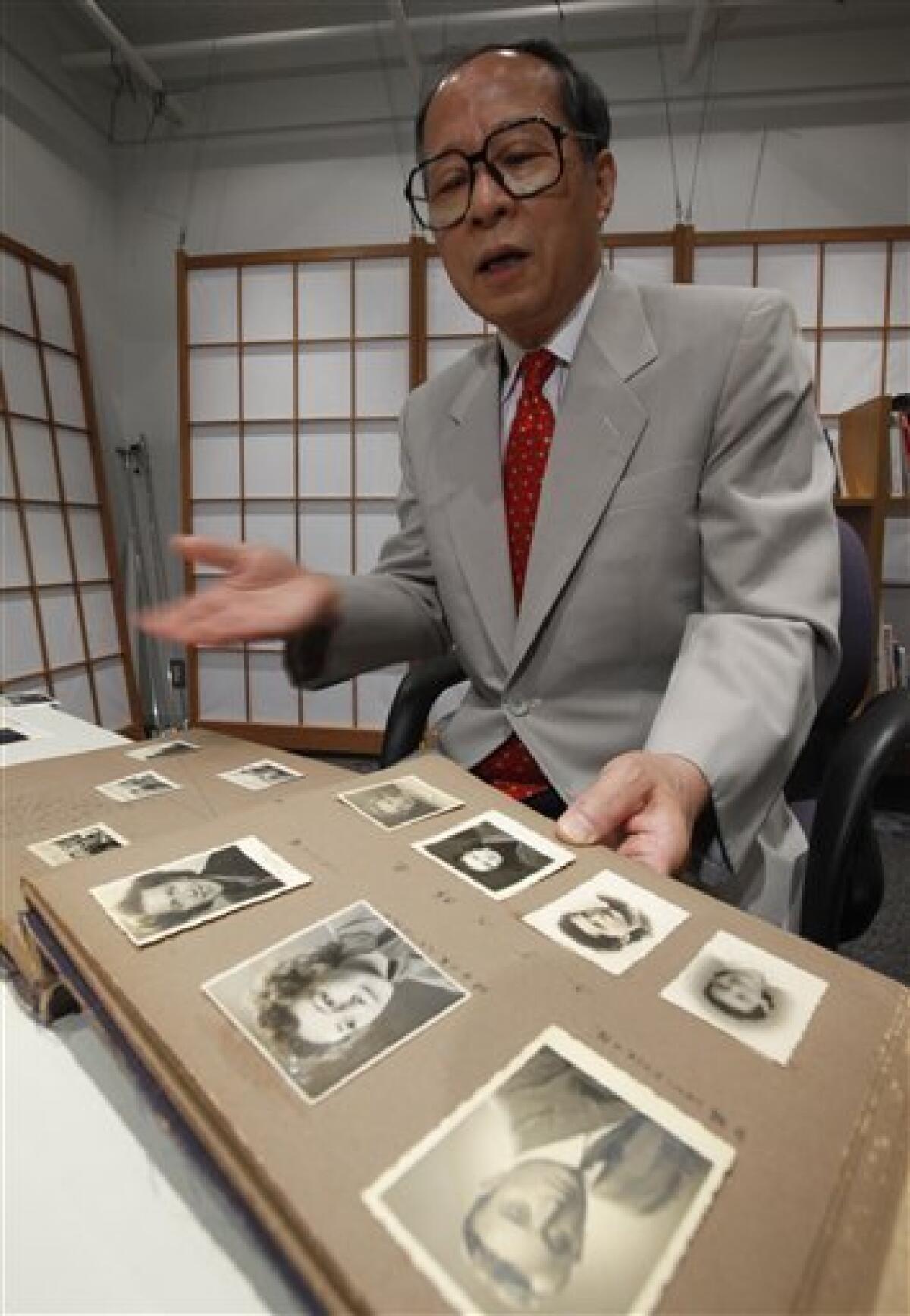 In this July 26, 2010, Akira Kitade photo, a diary owned by Japan Tourist Bureau employee Tatsuo Osako is displayed during an interview in Tokyo. The page in the foreground holds seven photos given to Osako by people whom Osako helped escape from Europe in the early days of World War II. The photographs are part of a recently discovered group of prints which throws more light on a subplot of the Holocaust: the small army of Japanese bureaucrats who helped shepherd thousands of Jews to safety. (AP Photo/Shizuo Kambayashi)