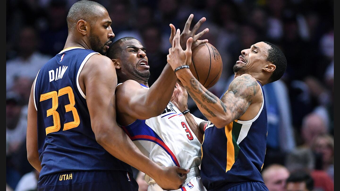 Clippers guard Chirs Paul tries to steal the ball away form Jazz guard George Hill, right, during the third quarter of Game 2 at Staples Center.
