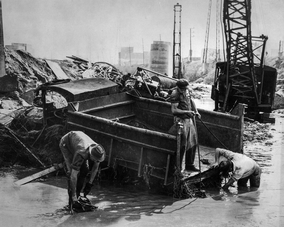 March 2, 1938: Salvage crew digs out a gravel truck that was mired in mud along the Los Angeles River.
