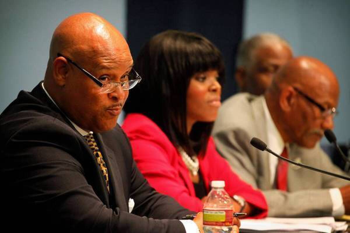 Omar Bradley, left, speaks at a mayoral candidates forum in March, flanked by political rival Aja Brown.