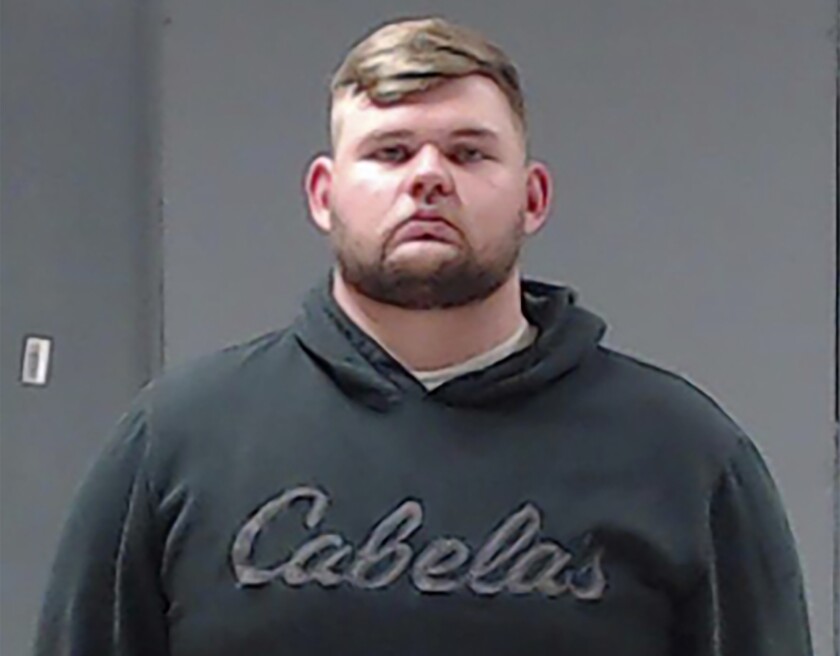 Booking photo of Wolfe City, Texas, Officer Shaun Lucas in street clothes. 