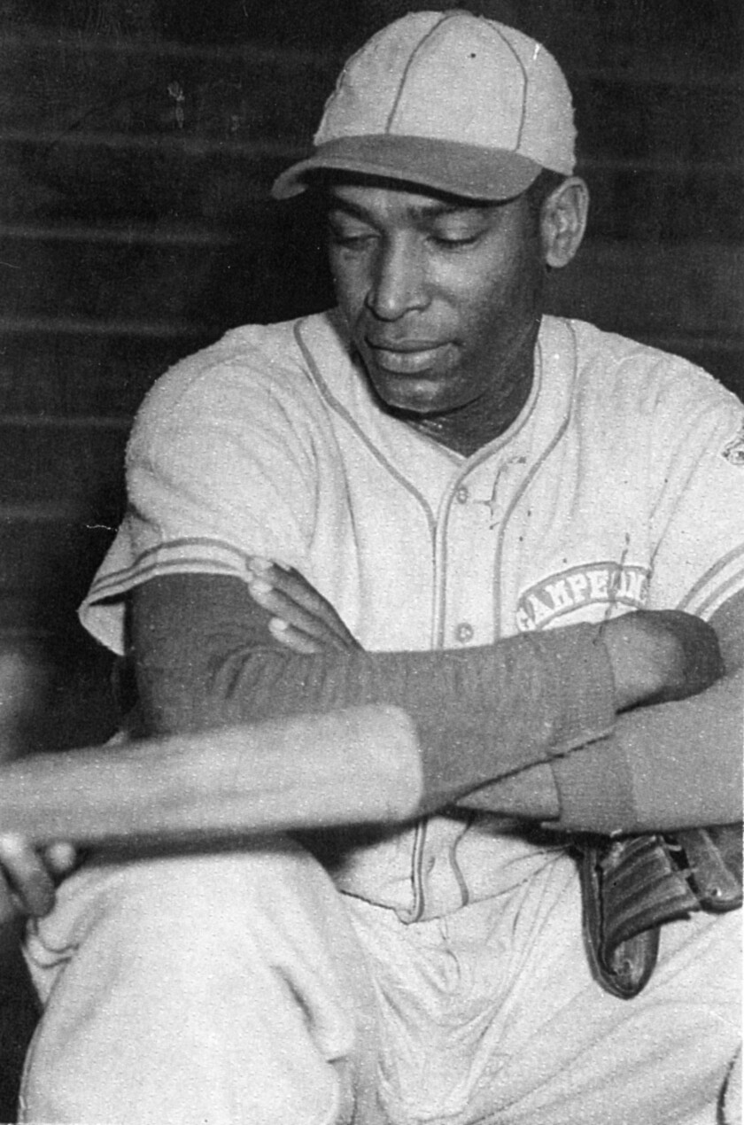 Martín Dihigo discusses batting before a game in the Venezuelan League in 1941.