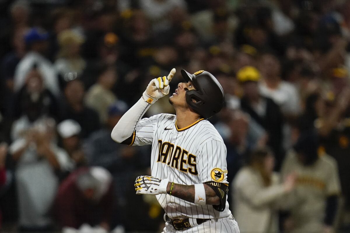 San Diego Padres' Manny Machado reacts after hitting two-run home run during the seventh inning of a baseball game against the Atlanta Braves, Thursday, April 14, 2022, in San Diego. (AP Photo/Gregory Bull)