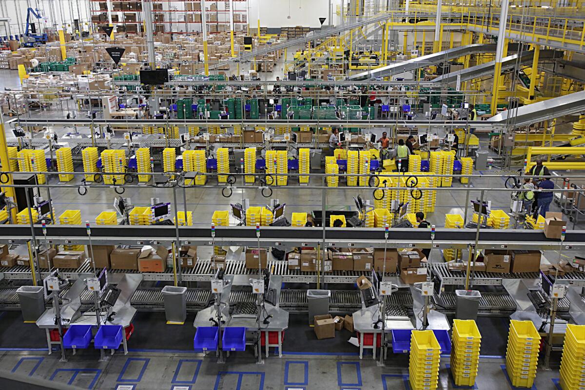 Employees work at Amazon's fulfillment center in San Bernardino in October 2013. Amazon plans to open a second fulfillment center in the city.