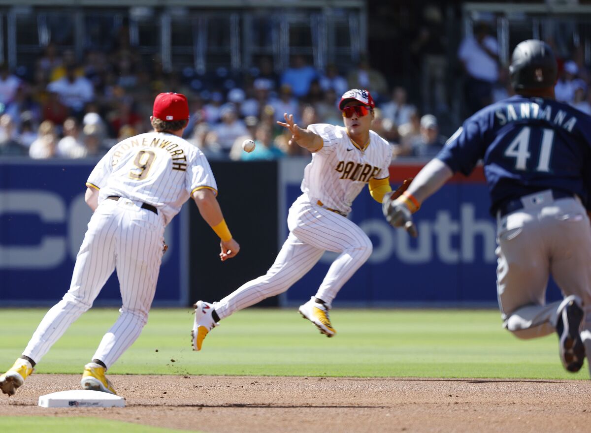 Padres shortstop Ha-Seong Kim tosses the ball to Jake Cronenworth 