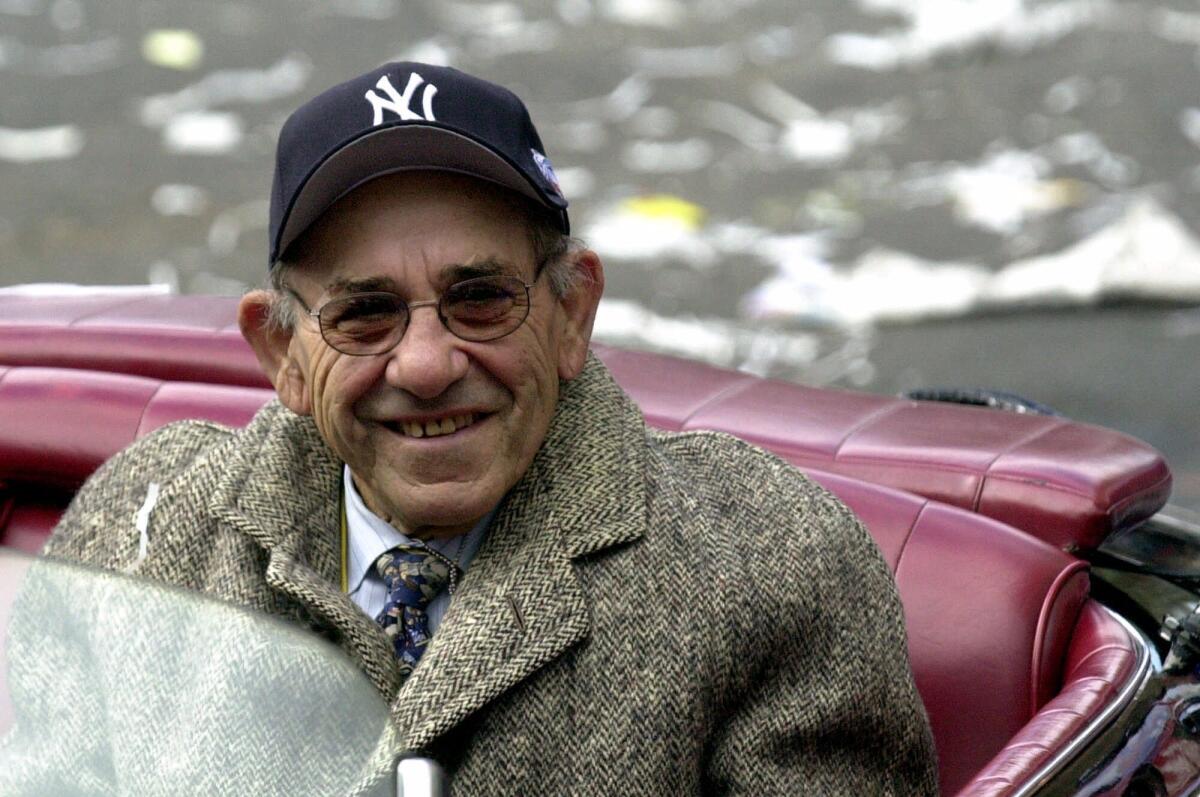 Yogi Berra rides in the Yankees World Series victory parade in 2000.