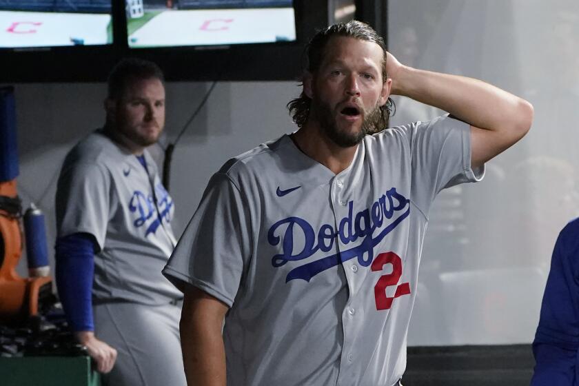 Los Angeles Dodgers starting pitcher Clayton Kershaw walks through the dugout during a rain delay in the third inning of a baseball game between the Dodgers and the Cleveland Guardians, Wednesday, Aug. 23, 2023, in Cleveland. (AP Photo/Sue Ogrocki)